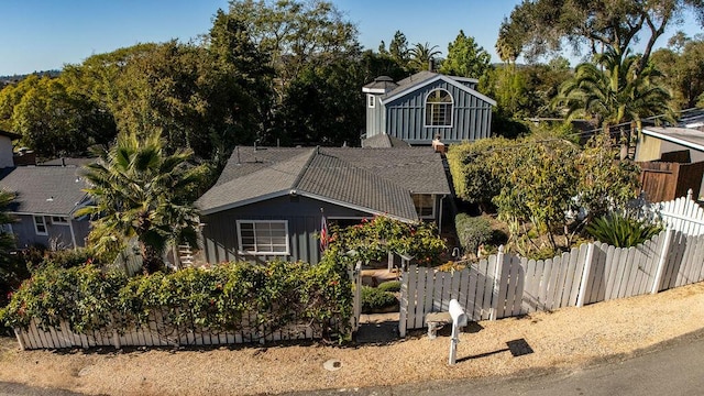 view of front of home with fence and board and batten siding