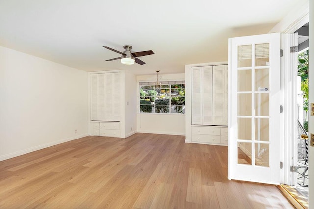 unfurnished room featuring ceiling fan, baseboards, and light wood-style floors