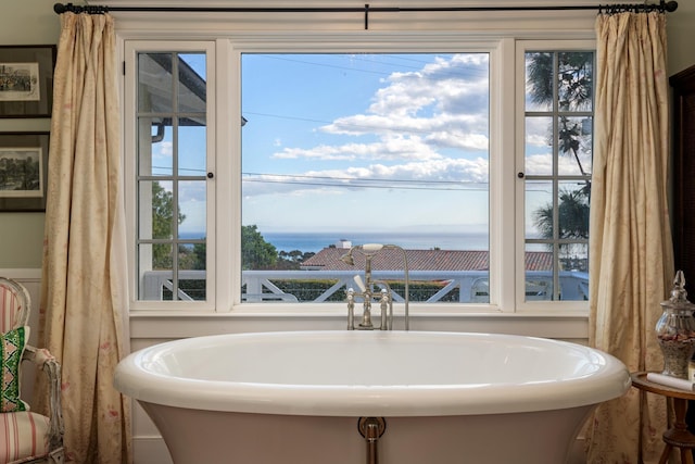 full bathroom with a sink and a soaking tub