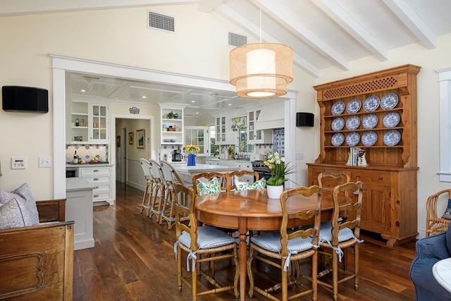 dining area featuring lofted ceiling with beams, visible vents, and dark wood finished floors