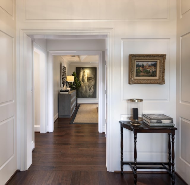 hall with dark wood-type flooring and baseboards