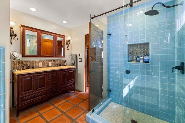 full bathroom with tile patterned flooring, double vanity, recessed lighting, and tiled shower