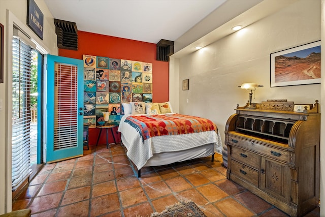 bedroom featuring access to outside and stone finish floor