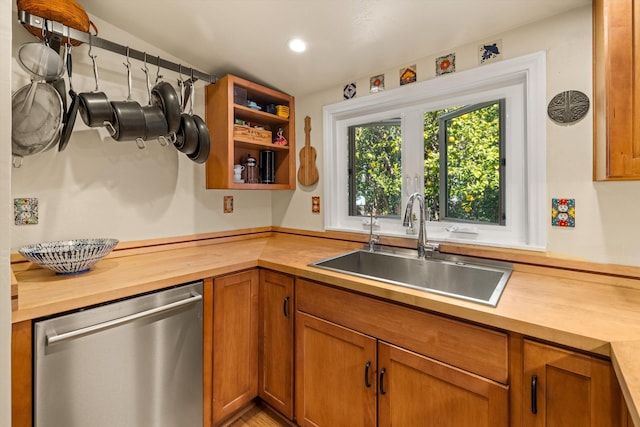 kitchen featuring dishwasher, a sink, brown cabinets, and butcher block countertops