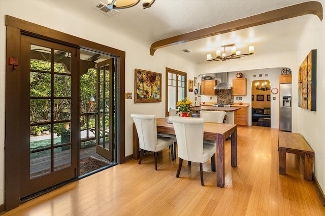 dining room featuring baseboards, visible vents, beamed ceiling, a notable chandelier, and light wood-type flooring