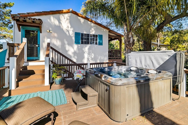 wooden deck featuring a hot tub