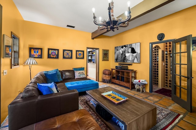 tiled living area with visible vents and a chandelier