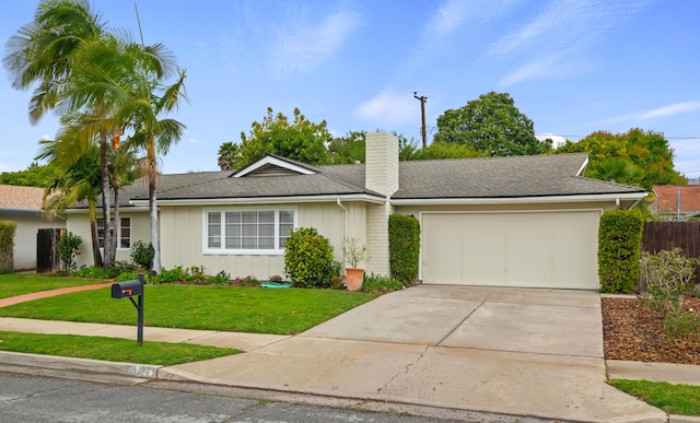 ranch-style house with a front lawn, roof with shingles, concrete driveway, an attached garage, and a chimney