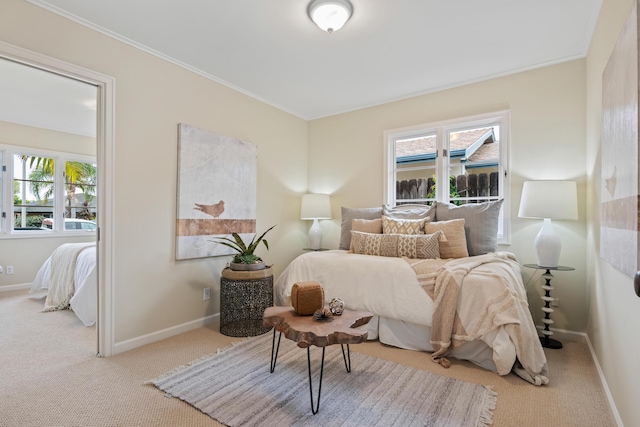 carpeted bedroom featuring baseboards and ornamental molding