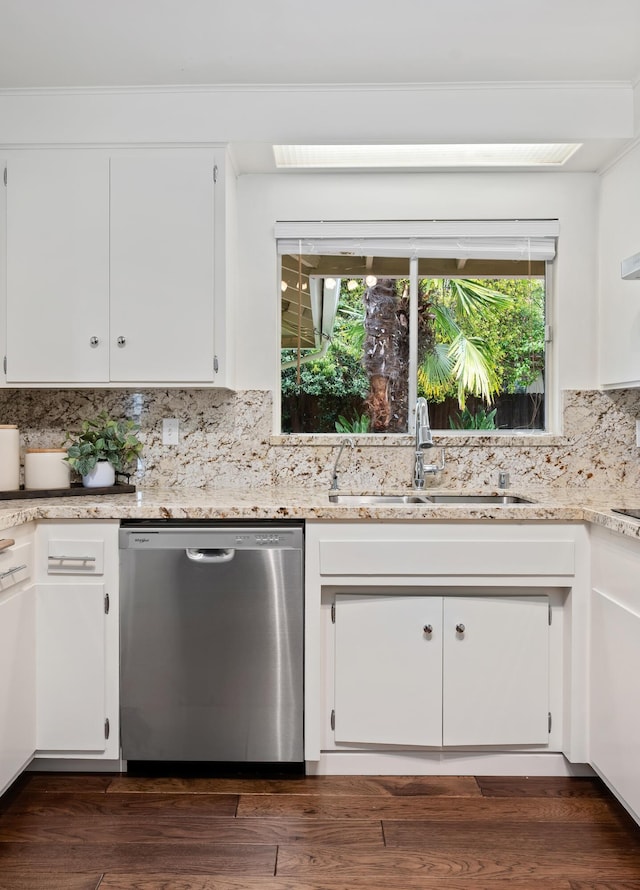 kitchen featuring dark wood-style floors, white cabinetry, a sink, stainless steel dishwasher, and tasteful backsplash