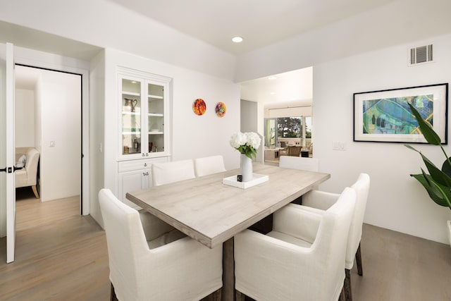 dining room featuring light wood-type flooring, visible vents, and recessed lighting