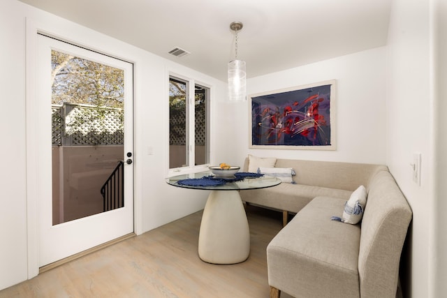 dining area with visible vents and wood finished floors