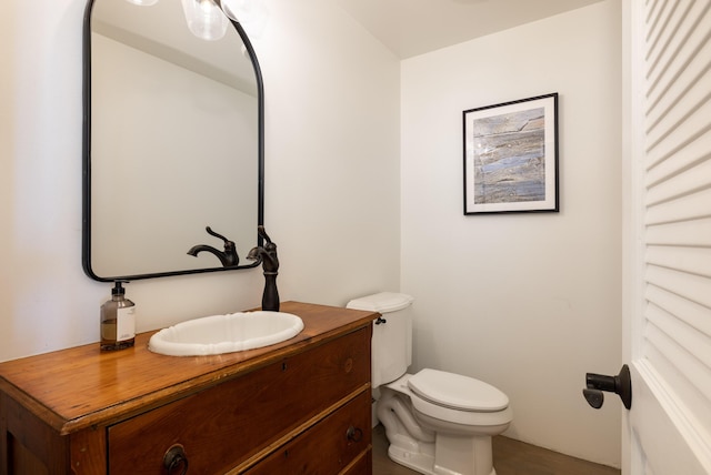 bathroom featuring toilet and vanity