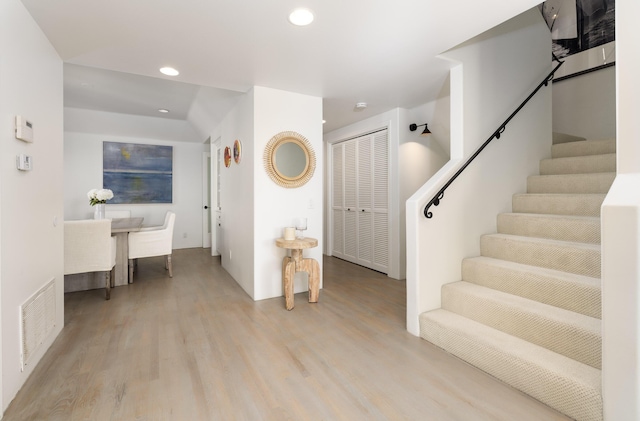 interior space with recessed lighting, visible vents, wood finished floors, and stairway