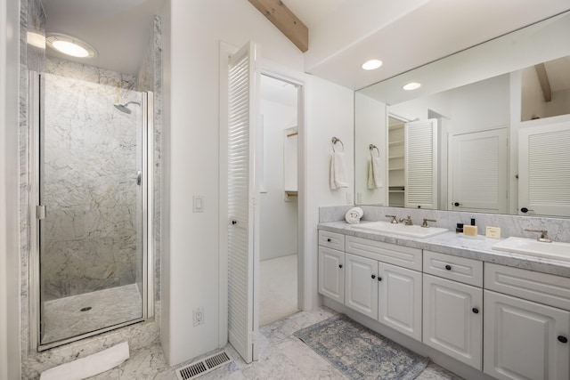 bathroom featuring a sink, a closet, marble finish floor, and visible vents