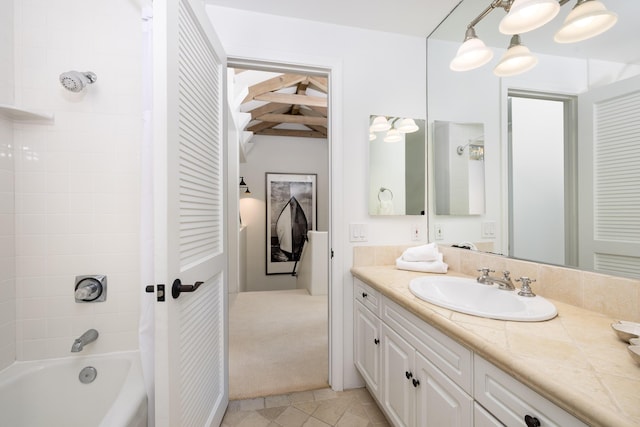 ensuite bathroom featuring connected bathroom, shower / bath combo with shower curtain, beam ceiling, tile patterned floors, and vanity