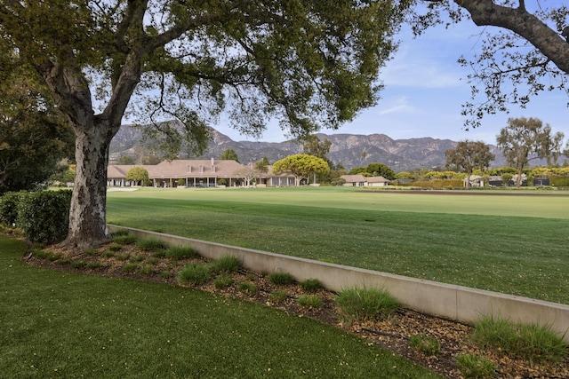 surrounding community featuring a mountain view and a yard