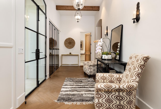 entryway with arched walkways, beamed ceiling, and baseboards