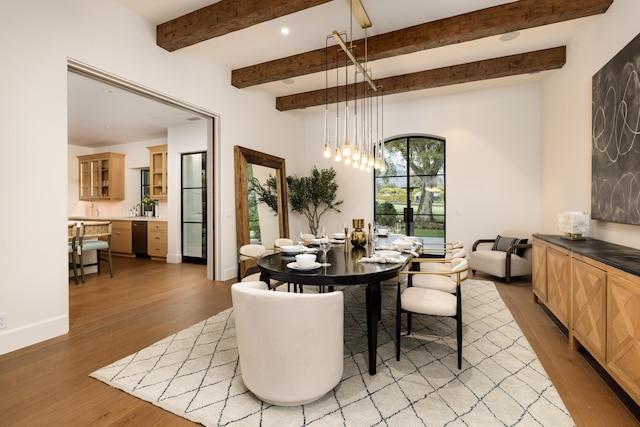 dining area featuring baseboards, recessed lighting, beamed ceiling, light wood-type flooring, and a chandelier