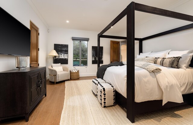 bedroom featuring recessed lighting, baseboards, light wood-style floors, and ornamental molding