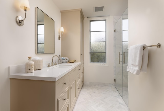 full bathroom with vanity, a shower stall, and visible vents