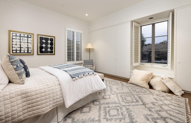 bedroom with recessed lighting, crown molding, and wood finished floors