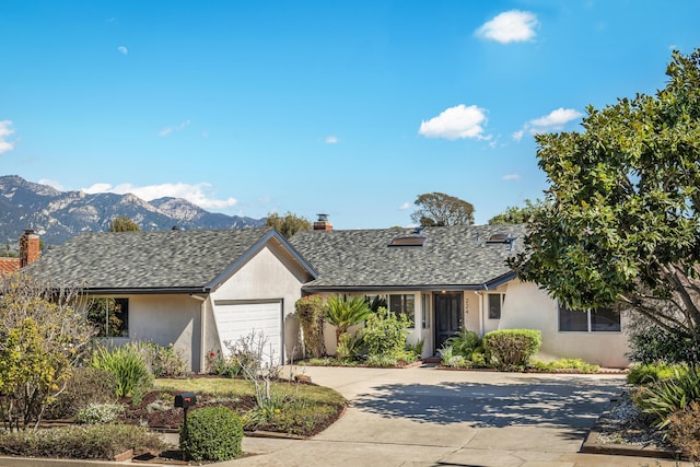 ranch-style home with a garage, stucco siding, concrete driveway, and roof with shingles