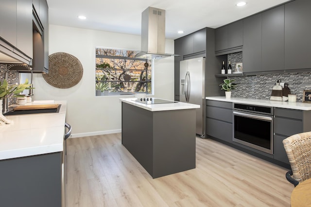 kitchen featuring backsplash, a center island, island range hood, stainless steel appliances, and modern cabinets