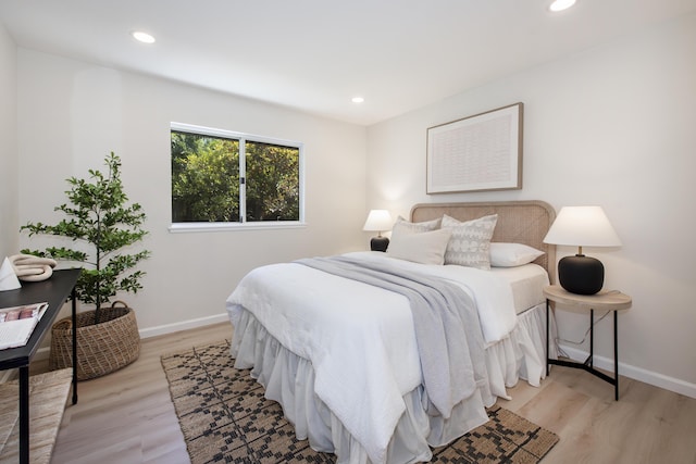 bedroom with recessed lighting, baseboards, and light wood-style flooring