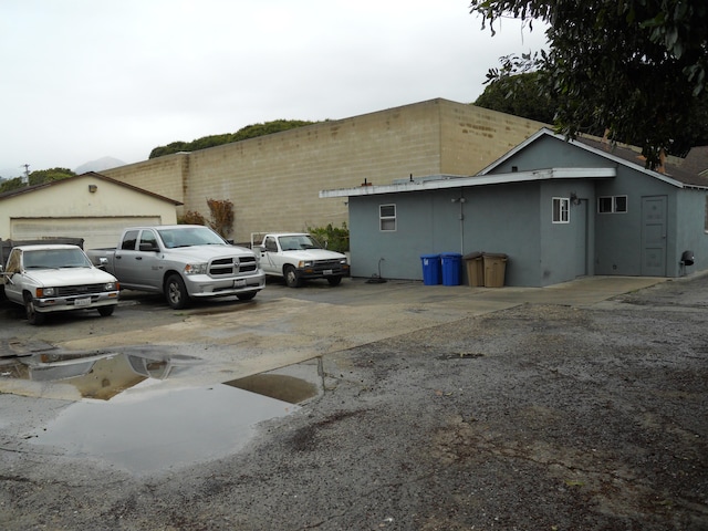 exterior space with stucco siding, an outdoor structure, and a garage