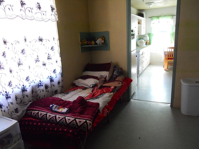 bedroom featuring concrete floors