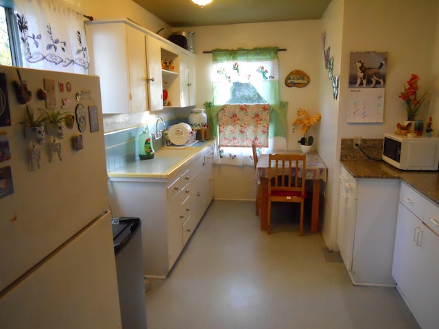 kitchen featuring open shelves, white appliances, and white cabinets