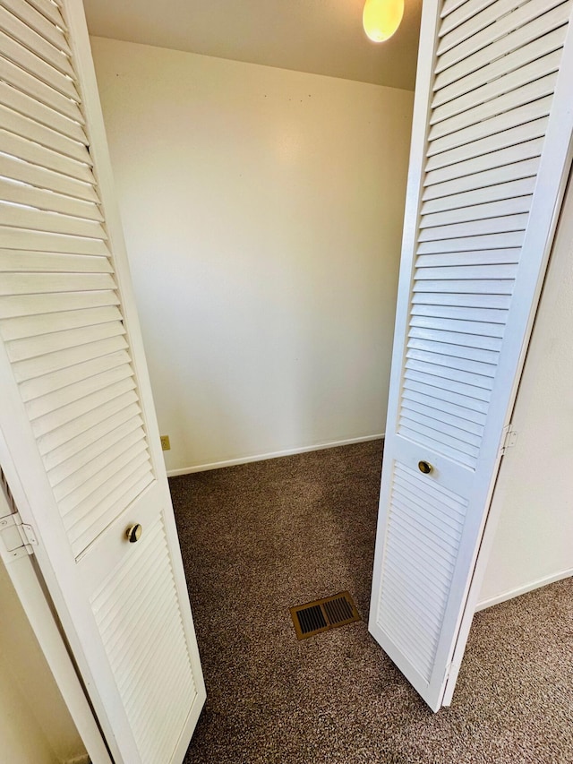 interior space with carpet flooring, baseboards, and visible vents