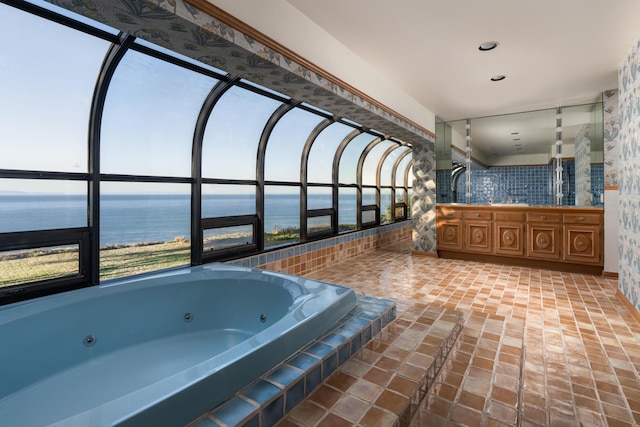 bathroom featuring a water view and a jetted tub