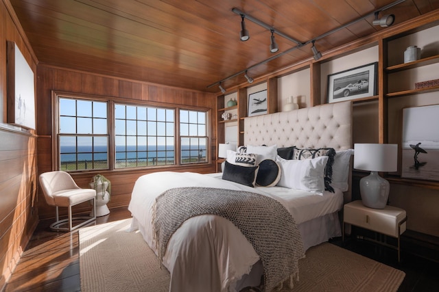 bedroom with wood walls and wood ceiling