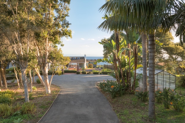 surrounding community featuring an outbuilding, an exterior structure, and driveway