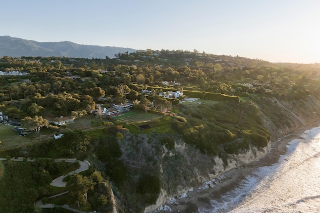 drone / aerial view featuring a mountain view and a wooded view