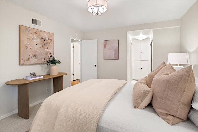 bedroom featuring visible vents, baseboards, and carpet