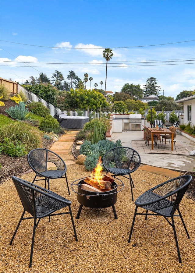 view of patio / terrace with fence and an outdoor fire pit