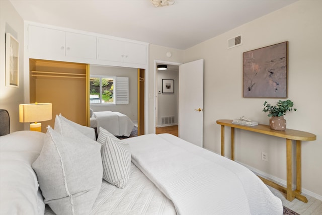 bedroom with baseboards, visible vents, and a closet