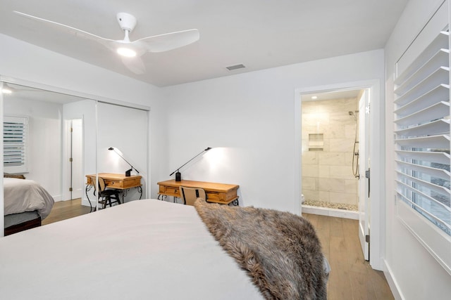 bedroom with light wood-type flooring, visible vents, a closet, connected bathroom, and ceiling fan