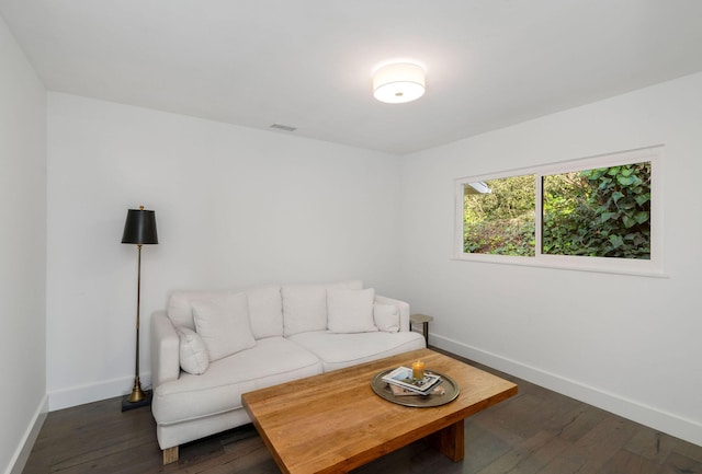 living area with visible vents, dark wood-style floors, and baseboards