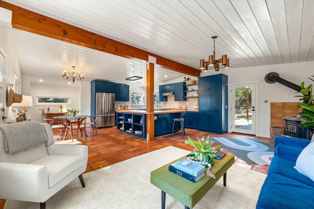 living room featuring tile patterned floors, beam ceiling, a notable chandelier, recessed lighting, and a wood stove