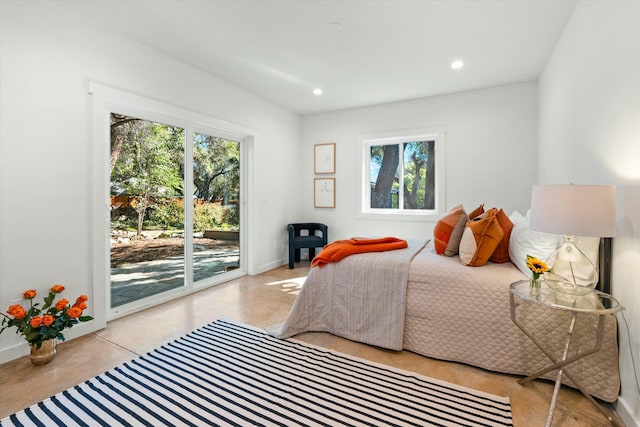 bedroom with recessed lighting, baseboards, finished concrete flooring, and access to exterior