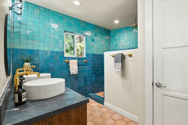 bathroom with vanity, recessed lighting, walk in shower, tile patterned floors, and tile walls