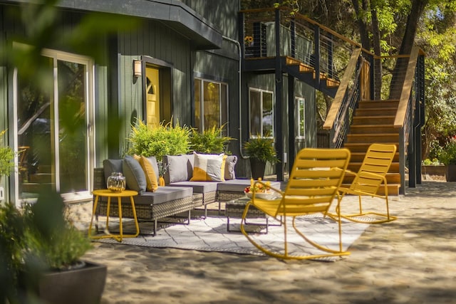 view of patio / terrace featuring outdoor lounge area and stairway