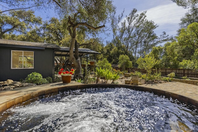 view of yard with a jacuzzi, a patio, and fence