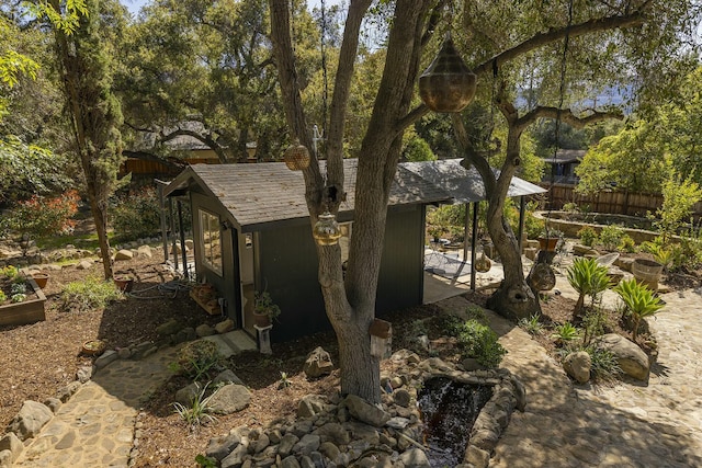 view of outbuilding featuring fence