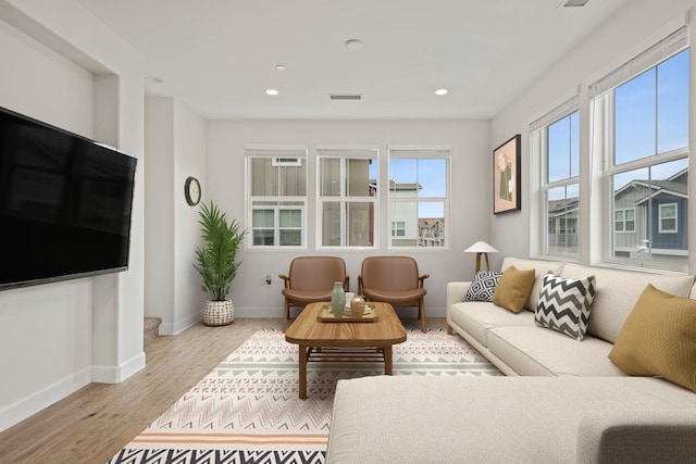 living room featuring visible vents, recessed lighting, wood finished floors, and baseboards