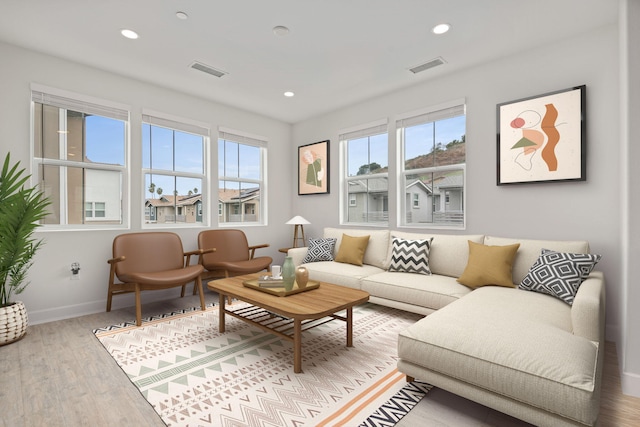 living room with recessed lighting, wood finished floors, and visible vents